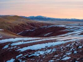 Scenic view from snow-covered stony pass to beautiful mottled rocks photo