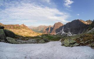 Snowy sunny stony pass, large colorful mountain range photo