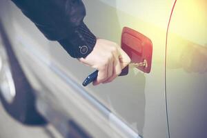 A person is holding a key to a car door photo