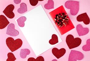 Blank sheet of paper with copy space to write your own text and red envelope on the pink background. Concept for Valentin's day. Place for text. photo