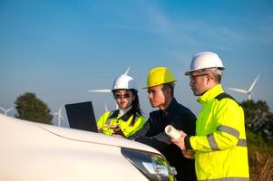 Engineers brainstorm on a plan to inspect the performance of wind turbines in the field using a pickup truck to survey photo