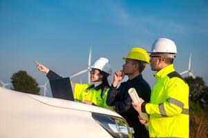 Engineers brainstorm on a plan to inspect the performance of wind turbine photo