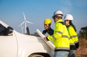 Engineers brainstorm on a plan to inspect the performance of wind turbines in the field. photo