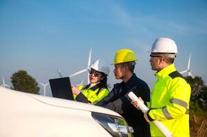 Engineers brainstorm on a plan to inspect the performance of wind turbines in the field photo