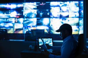 Security guards are monitoring multiple CCTV monitor photo
