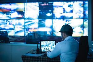 Security guards are monitoring multiple CCTV monitors photo