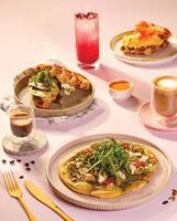 for brackfast a table topped with plates of food and drinks photo