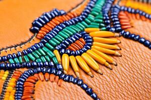 Close-up view of intricate Native American beadwork on a leather pouch showcasing traditional craftsmanship and vibrant color patterns photo