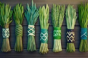 Collection of Native American herbs featuring sage, sweetgrass, and cedar arranged in bundles on wooden surface with soft natural lighting emphasizing texture photo