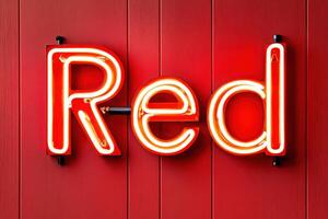 Bright red neon sign illuminating the word Red against a vibrant red wall creating a striking visual effect in a modern space photo