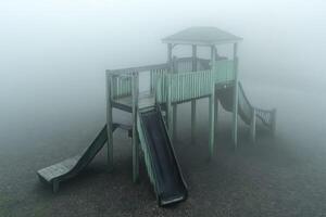 Foggy Playground Wooden Structure With Slides photo