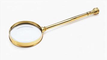 Antique gold-colored magnifying glass with a plain handle. photo