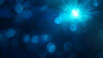 Glittering blue starburst in a bokeh effect background photo
