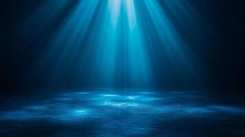 Blue light rays streaming over dark surface space photo
