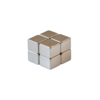 A polished set of metallic cubes arranged in an abstract formation on a reflective surface. png