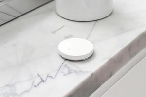 Minimalist smart home sensor on marble countertop in modern bathroom design photo