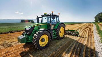 Modern green tractor plowing a serene farm landscape under clear blue sky photo
