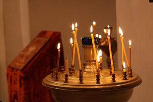 Burning candles in a tranquil church setting with soft lighting photo
