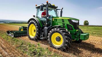 Modern green tractor plowing a field on a sunny day in rural landscape photo