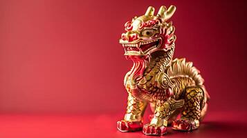 Golden dragon figurine on red background,symbol of power and prosperity photo