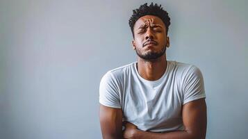 Emotional expression of a man reflecting on personal memories in a minimalist studio setting photo