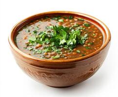 Lentil soup served in a rustic bowl garnished with fresh herbs ready for a comforting meal photo