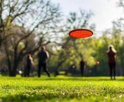 Frisbee flying through the air in a sunny park during an afternoon gathering of friends photo