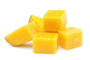 Yellow mango cubes arranged on a white background showcasing fresh fruit ideal for desserts and snacks photo