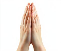 Hands placed together in a gesture of prayer or greeting against a light background photo