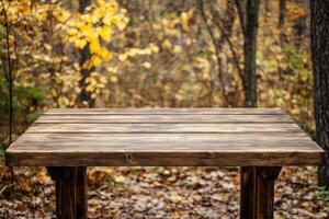 Wooden table in autumn forest with colorful leaves on the ground and trees in the background photo