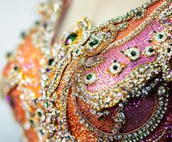 Sparkling details of an intricately designed costume showcasing vibrant colors and embellishments photo