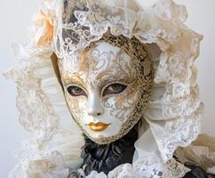 Elegant mask worn by a mannequin showcasing detailed lace and costume design at a cultural event in a gallery photo