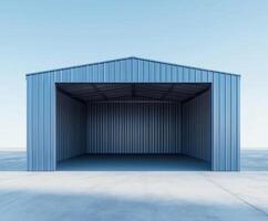 Spacious blue metal storage building without contents in a clear sky setting near an open area photo