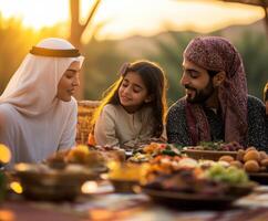 Family enjoying a sunset meal together in a desert setting with traditional dishes and vibrant colors photo