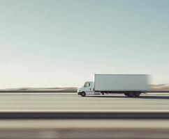Large white truck travels along empty highway under clear blue sky during daytime photo
