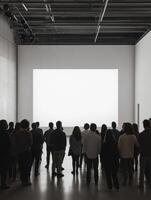 Audience observes presentation in modern gallery space during evening art event showcasing contemporary works photo