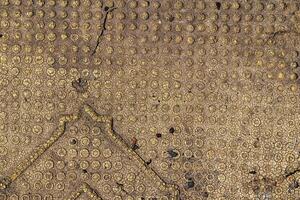 A close up of a gold patterned surface photo