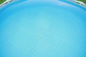 Swimming pool on a lawn background as a background. Swimming pool with water for swimming. Relaxation photo