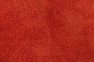Suede in a warm shade of red as a background. photo