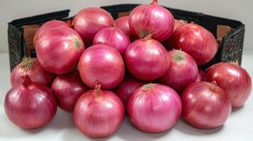 Freshly harvested red onions glisten together in a charming display photo