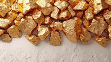 Sparkling golden rocks create a striking contrast on a textured white surface photo