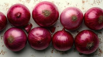 Fresh red onions arranged beautifully on a textured surface photo