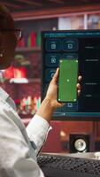 Vertical Woman at home holding mockup smartphone asks questions to AI LLM virtual assistant answering prompts. Person with chroma key phone receiving information from artificial intelligence GPT, camera A video