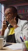 Vertical Manager in home office arguing with employee during phone call, looking at laptop. Team leader scolding worker during telephone call after finding errors in documents, camera A video