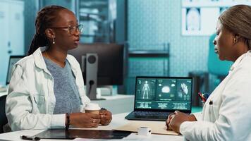 Health specialist measuring the oxygen saturation and pulse rate using oximeter during routine checkup, consult a black girl patient with modern medical tools. Vital signs measurement. Camera A. video
