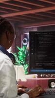 Vertical Admin writing code on computer and doing maintenance on artificial intelligence neural networks computerized model. Tech support expert typing on keyboard, doing checkup on AI systems, camera A video