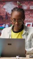 Vertical Worker at home starting job shift, opening laptop to analyze data at desk, compiling analytical reports. Remote employee beginning tasks, using notebook device, writing down information, camera B video