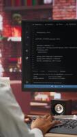 Vertical Software developer wearing headphones using computer at home for artificial intelligence computing simulating human brain. IT expert listening music and working with AI deep neural networks, camera B video