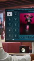 Vertical Graphic designer designing UX for AI software turning text prompt into photos. IT specialist drinking coffee using machine learning tech to build text to image models, camera A video