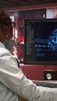Vertical Programmer using computer at home for artificial intelligence computing simulating human brain through self learning algorithms. Employee working with AI deep neural networks on desktop PC, camera A video